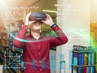Smart young man in a library travels in a virtual futuristic world with augmented reality. Concept: educational, future, library, and immersive technology.