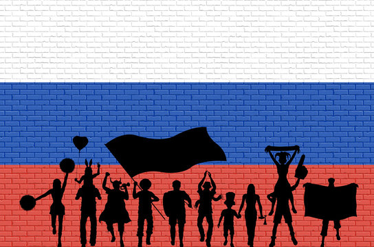 Russian supporter silhouette in front of brick wall with Russia flag