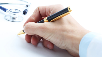 closeup .hand of doctor writing a prescription
