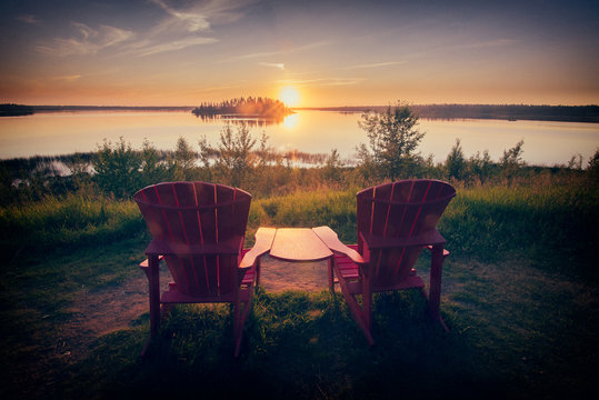 Two chairs looking at sunset over lake.  Authentic looking Instagram post.