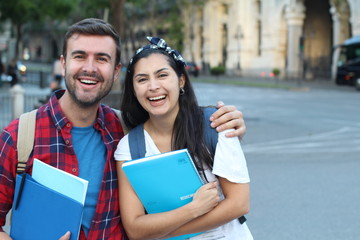 Happy couple of university students outdoors