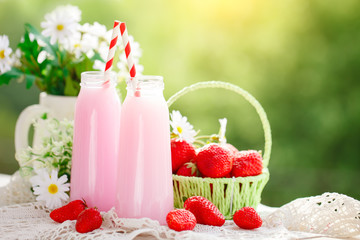 Strawberry cocktail or milkshake in a jar, basket with strawberries on a picnic, healthy food for Breakfast and snacks. Selective focus.