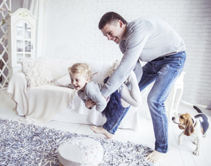 loving father plays with his baby daughter