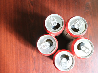 a few beer cans on a dark background