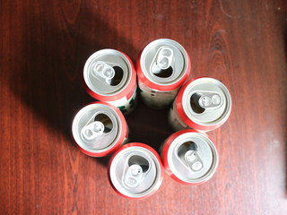 a few beer cans on a dark background