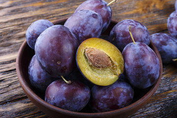 Garden plums in bowl. Organic food.