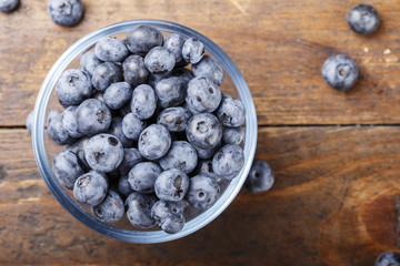 ripe organic bog whortleberry in a wooden plate