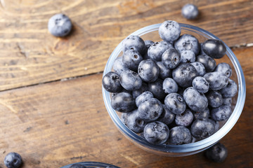 ripe organic bog whortleberry in a wooden plate