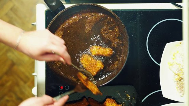 Nuggets. The process of frying in a frying pan. Crispy crust.