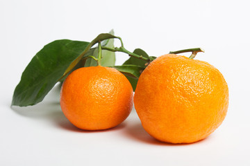 Pile of mandarins with leaf isolated on white background