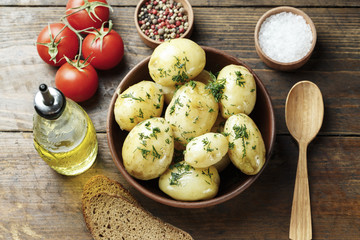 Dinner set with potatoes, summer vegetables, with young onions and tomatoes.