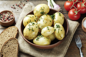 Dinner set with potatoes, summer vegetables, with young onions and tomatoes.