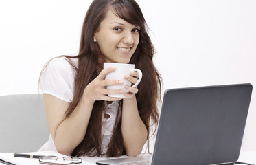 young woman with Cup of tea sitting in the workplace