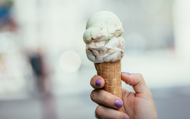 Eistüte in Mädchenhand, Sommer, lackierte Fingernägel