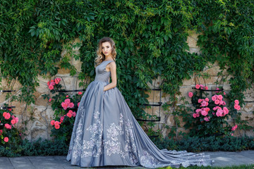 Fototapeta premium Beautiful girl with roses. Beauty model woman face. Perfect Skin
