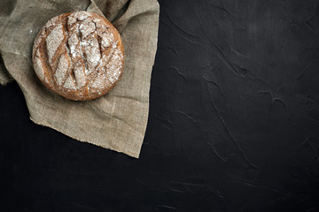 Freshly baked bread on dark kitchen table, top view