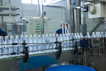 Closeup on mineral water bottles in raw and lines