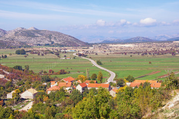 Fototapeta na wymiar Karst field landscape. Bosnia and Herzegovina, Zubacko polje. View of village of Grab and road to city of Trebinje