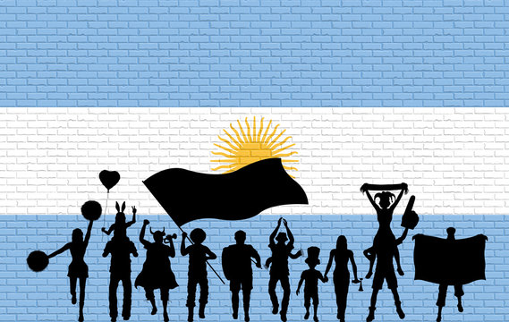 Argentinian supporter silhouette in front of brick wall with Argentina flag