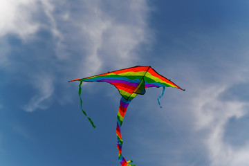 kite against the blue sky and white clouds