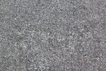 Marble or granite texture is used as a background. Abstract gray texture with many holes.