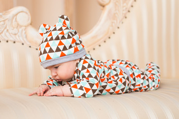 Cute newborn baby boy in sunny room