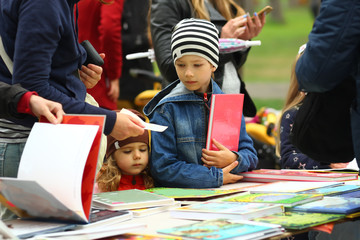 Children choosing and buying books at the book fair
