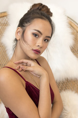 young Thai model posing for beauty photography in small boutique