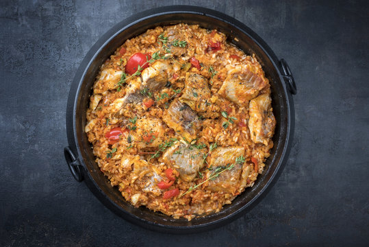 Traditional Louisiana Fish Jambalaya Dish Creole Cajun With Rice And Tomatoes As Top View In A Pot With Copy Space