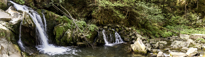 Fototapeta na wymiar Kamianetskyi waterfall in carpathian forest, national park Skolevski beskidy, Lviv region of Western Ukraine