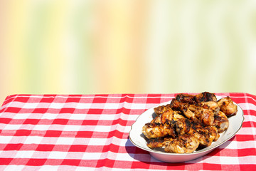 Fresh grilled chicken meat on table with bright pastel background. Copy space on left side.