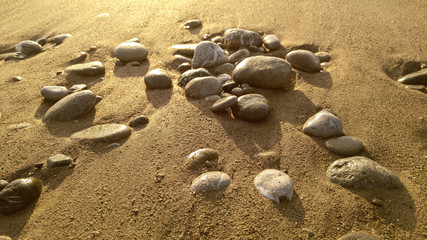 Fototapeta na wymiar Sea pebble on the sand , seasonal background, vintage hipster image