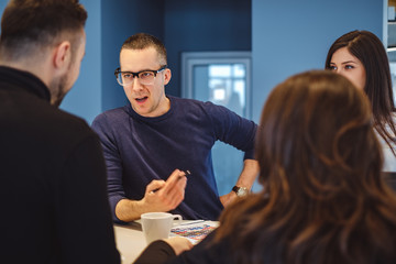 Man aggressively talking at the office meeting to his colleagues