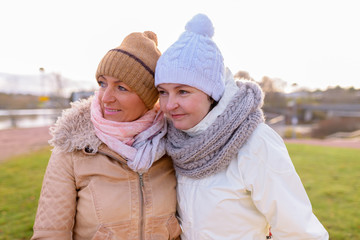 Fototapeta premium Two mature beautiful women together against scenic view of natur