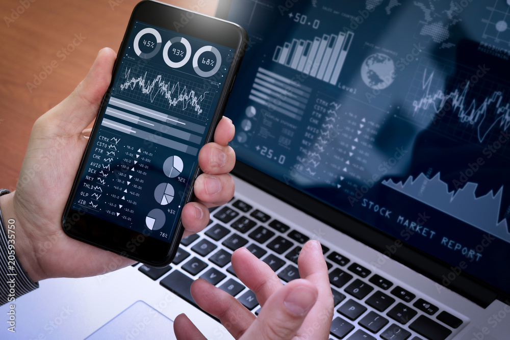 Poster Investor analyzing stock market report and financial dashboard with business intelligence (BI), with key performance indicators (KPI).Businessman using smart phone with laptop computer.