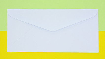 white envelope mail on yellow and green background