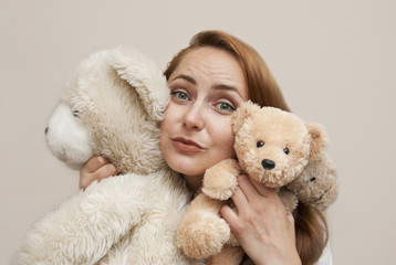 Red-Haired Young Woman in White dress Holding Ivory Soft Toy Teddy Bear Isolated Copy space. Education. Parenting. Play.