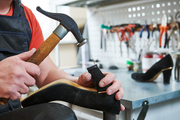 Shoemaker repair female spike shoe. Hammering tip on heel