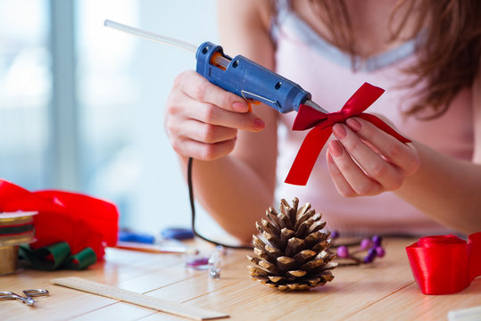 Woman doiing DIY festive decorations at home