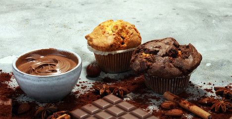 Chocolate muffin and nut muffin, homemade bakery on grey background