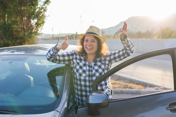 Smilling woman holding new car key
