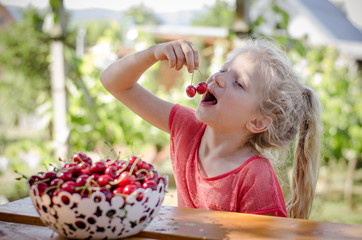 girl with ripe red cherry fruit