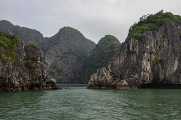 Beautiful limestone mountain scenery at Ha Long Bay, North Vietnam. Cloudy winter weather