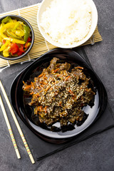 Roasted beef in sauce with spices and sesame seeds in Asian style. Mongolian meat.
