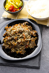 Roasted beef in sauce with spices and sesame seeds in Asian style. Mongolian meat.