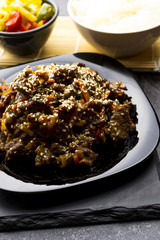 Roasted beef in sauce with spices and sesame seeds in Asian style. Mongolian meat.