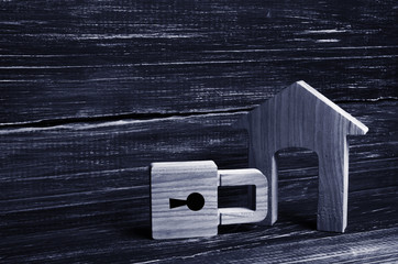 Wooden house with a padlock. House with a lock. Security and safety, collateral, loan for a...