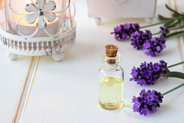 A bottle of essential oil with fresh blooming lavender