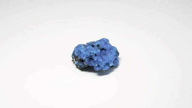 Macro shot of alum mineral isolated over white background and spinning around