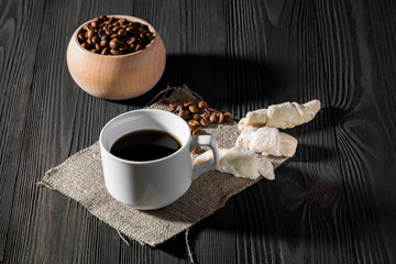 a cup of americano coffee on wood texture, still llife photography